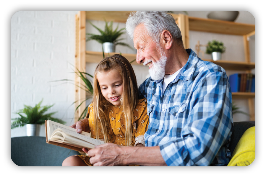 Grandparent reading to young girl